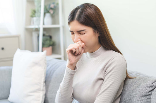 a woman coughing due to allergies