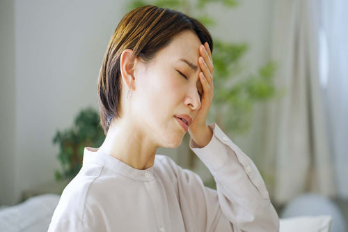 a woman suffering from allergy headache