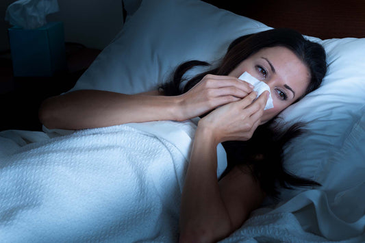 a woman suffering from nighttime nasal congestion