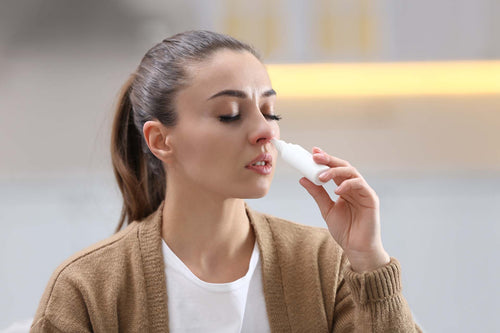 a woman using nasal spray