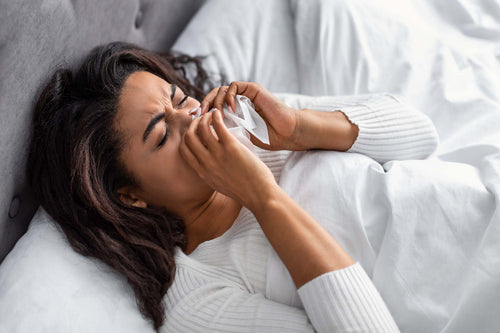 a woman waking up with a stuffy nose