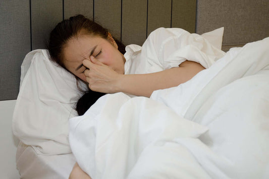 woman having trouble sleeping due to post nasal drip